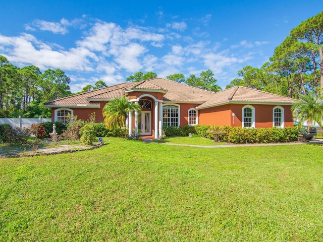 mediterranean / spanish-style house with a front lawn