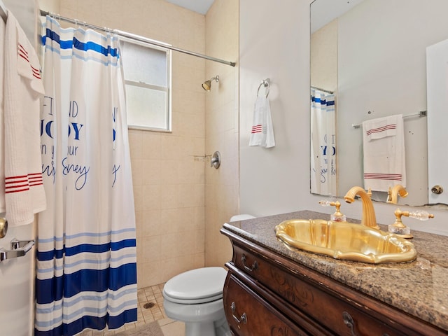 bathroom featuring curtained shower, tile patterned flooring, vanity, and toilet