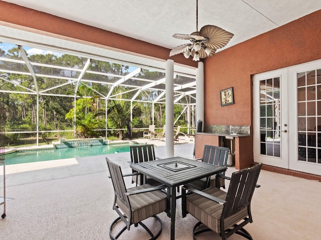 view of patio featuring glass enclosure, ceiling fan, and french doors