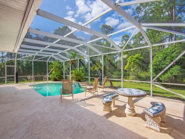 view of swimming pool with a lanai and a patio