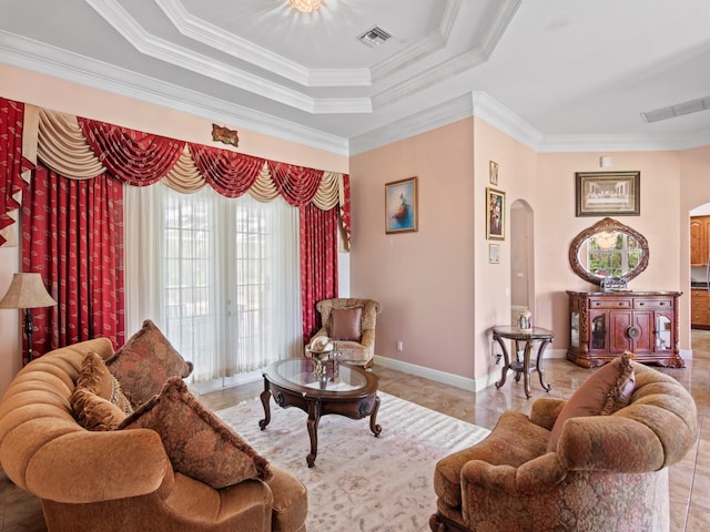 living room featuring a tray ceiling and ornamental molding