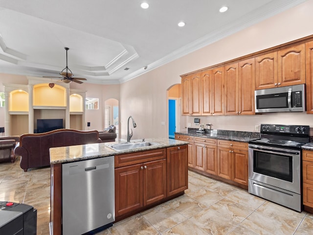 kitchen with a wealth of natural light, ceiling fan, sink, and stainless steel appliances