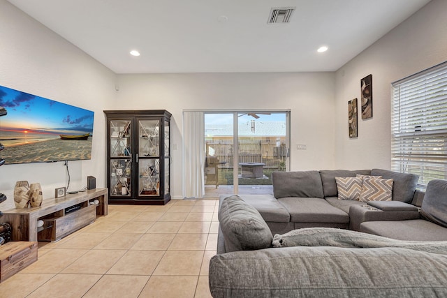 living area with light tile patterned floors, visible vents, and recessed lighting