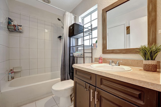 full bathroom with toilet, shower / bath combination with curtain, tile patterned flooring, vanity, and a textured wall