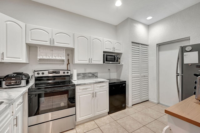 kitchen featuring light tile patterned floors, recessed lighting, white cabinets, and appliances with stainless steel finishes