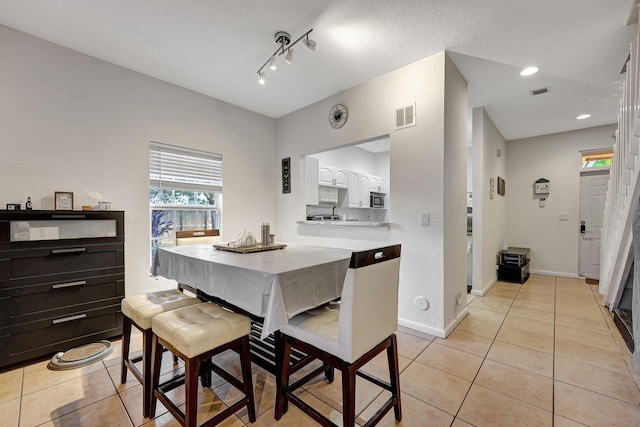 dining room featuring light tile patterned floors, visible vents, baseboards, and recessed lighting