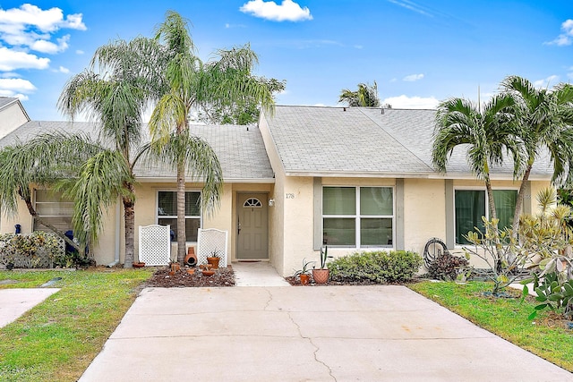 ranch-style house with a front lawn