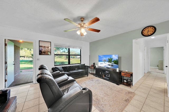 tiled living room with a textured ceiling and ceiling fan