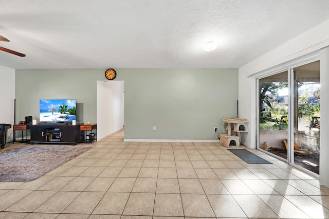 tiled living room featuring ceiling fan and a textured ceiling