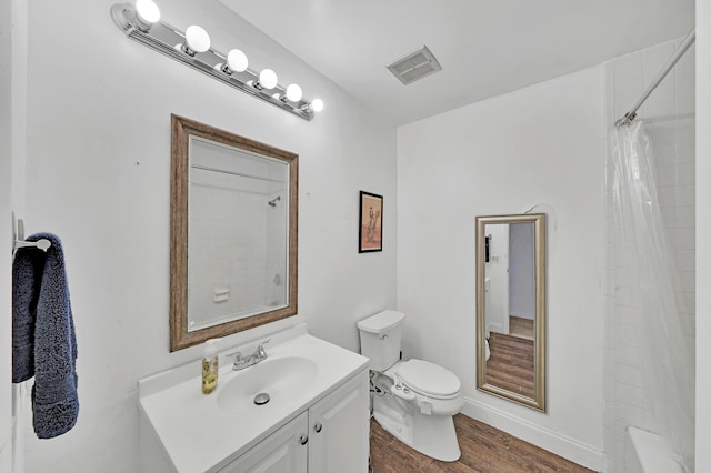 full bathroom with hardwood / wood-style floors, vanity, shower / bath combination with curtain, and toilet