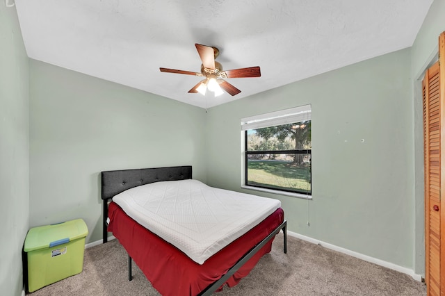 bedroom featuring ceiling fan, carpet floors, and a closet