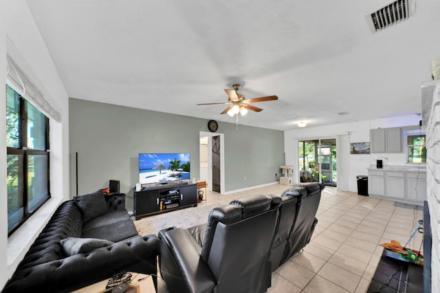 living room featuring ceiling fan and light tile patterned floors