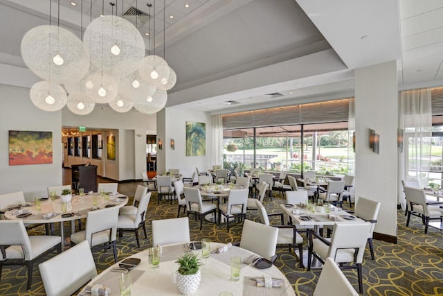 carpeted dining room with a tray ceiling