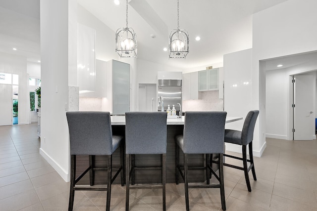 dining room featuring light tile patterned flooring and high vaulted ceiling