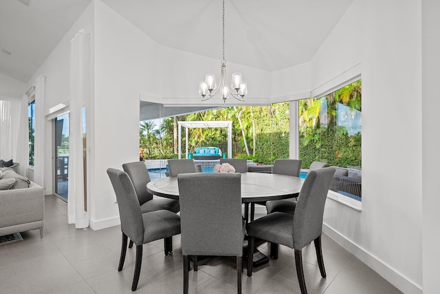 dining room featuring vaulted ceiling and an inviting chandelier