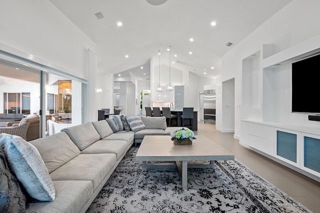 living room with a chandelier and vaulted ceiling