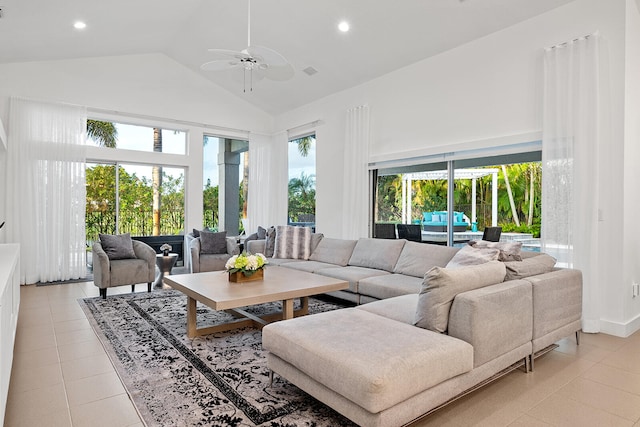 living room featuring ceiling fan, light tile patterned flooring, and high vaulted ceiling