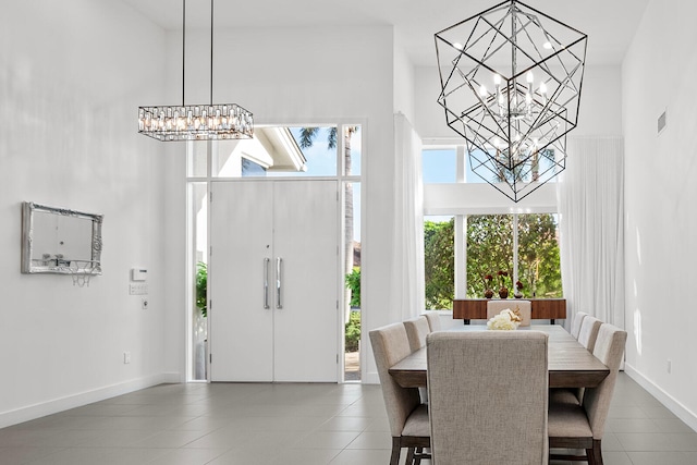 tiled entrance foyer featuring a towering ceiling