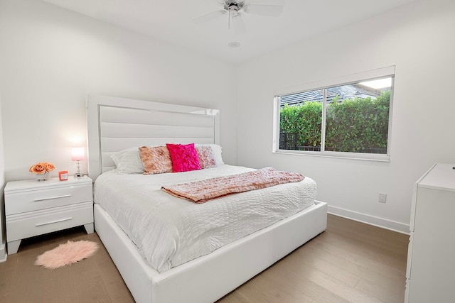 bedroom with ceiling fan and hardwood / wood-style flooring