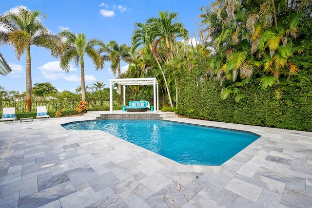 view of pool featuring a pergola, a patio area, and an outdoor hangout area