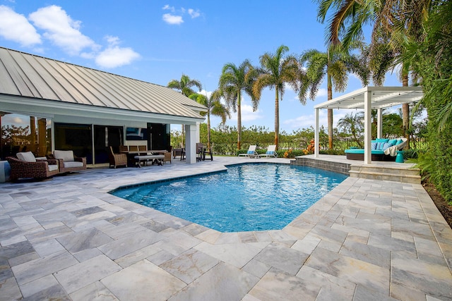 view of swimming pool with outdoor lounge area and a patio