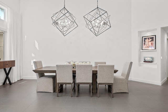 dining area featuring a chandelier and a high ceiling