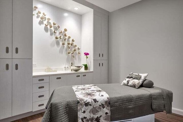 bedroom with dark wood-type flooring