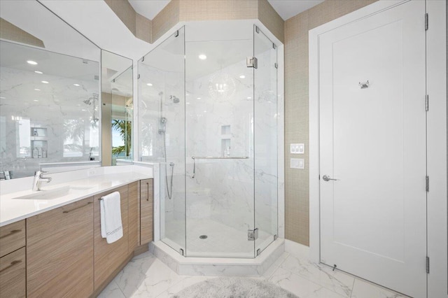 bathroom featuring vanity and a shower with shower door