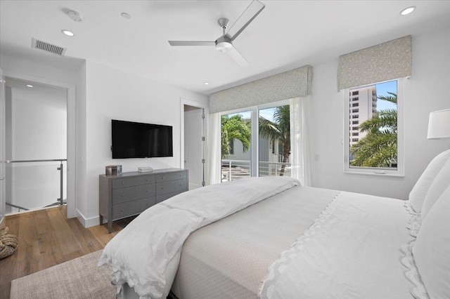 bedroom featuring ceiling fan, access to exterior, and wood-type flooring