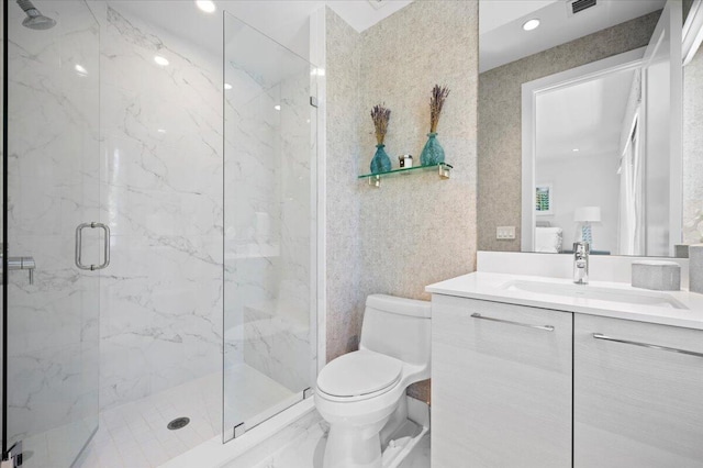 bathroom featuring vanity, an enclosed shower, and toilet