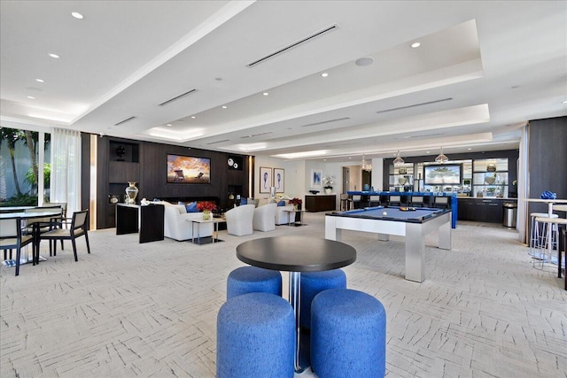 rec room featuring a raised ceiling, light colored carpet, and billiards