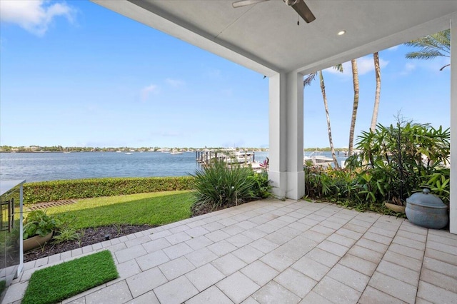 view of patio / terrace featuring ceiling fan and a water view