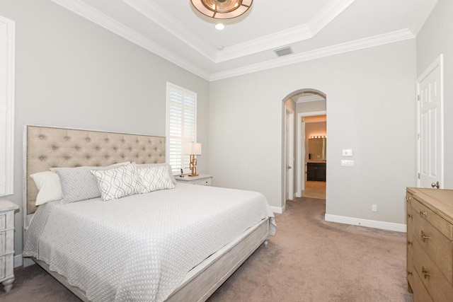 carpeted bedroom featuring crown molding and a tray ceiling