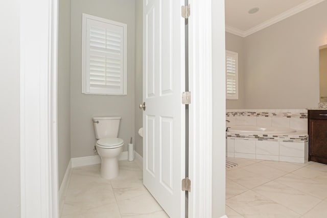 bathroom with a relaxing tiled tub, toilet, ornamental molding, and vanity