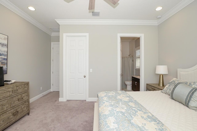 carpeted bedroom with connected bathroom, ceiling fan, and crown molding