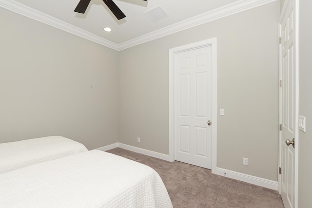 bedroom with light colored carpet, ceiling fan, and crown molding