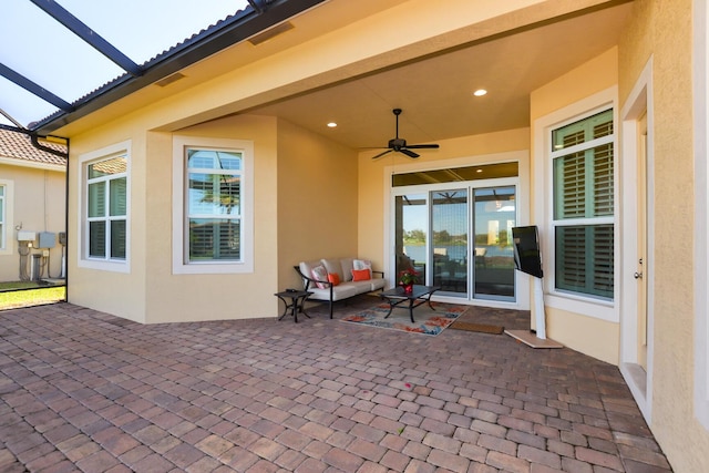 view of patio / terrace with outdoor lounge area, ceiling fan, and a lanai