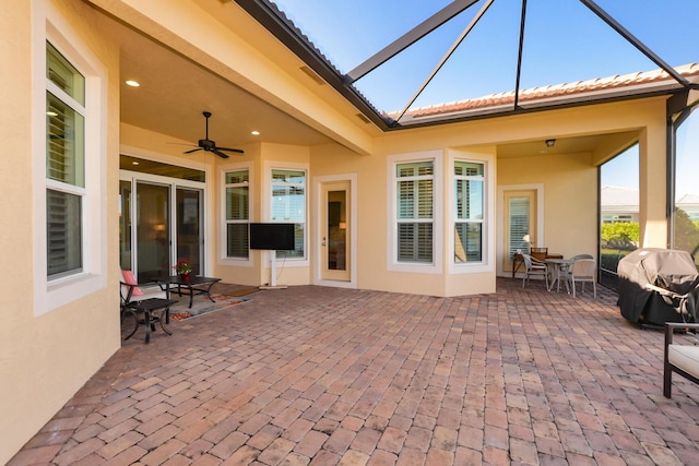 exterior space featuring ceiling fan, area for grilling, and a lanai