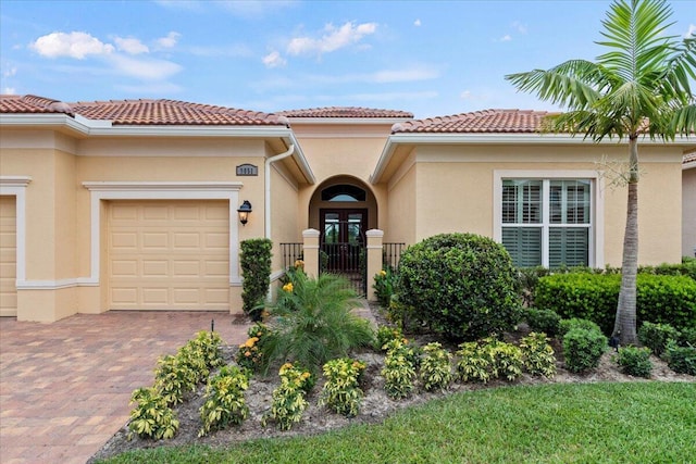 mediterranean / spanish-style home with a garage