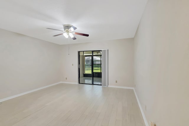 empty room with ceiling fan and light hardwood / wood-style flooring