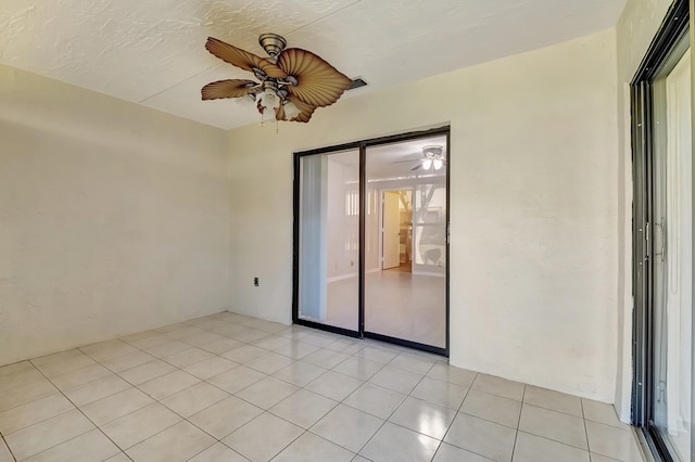 tiled empty room with ceiling fan