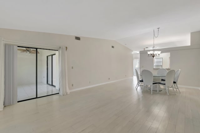 dining area featuring ceiling fan with notable chandelier, light wood-type flooring, and lofted ceiling