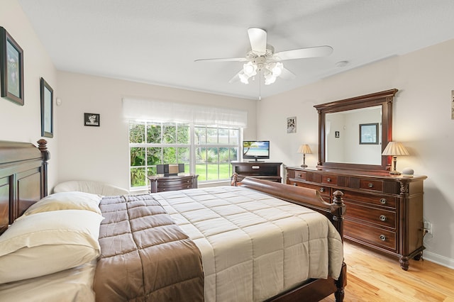 bedroom with light wood-type flooring and ceiling fan