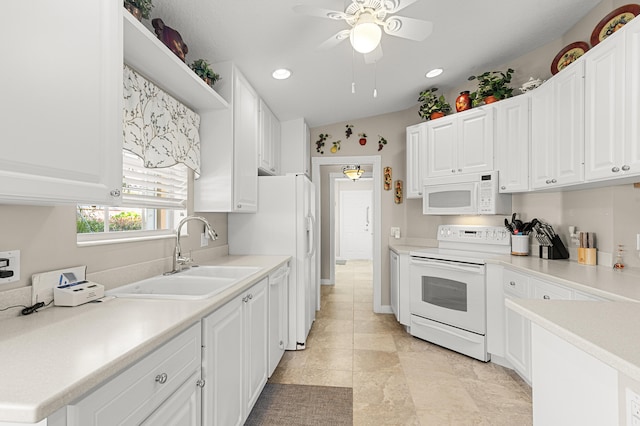 kitchen featuring white cabinetry, sink, ceiling fan, and white appliances