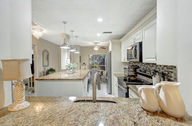 kitchen featuring white cabinets, ceiling fan with notable chandelier, sink, decorative light fixtures, and stainless steel appliances