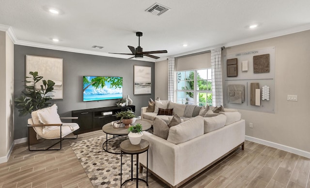 living area featuring visible vents, ornamental molding, wood tiled floor, a ceiling fan, and baseboards