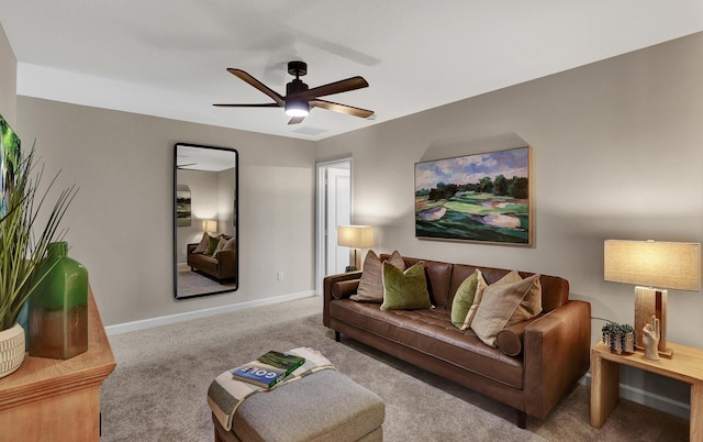 carpeted living room with ceiling fan and baseboards