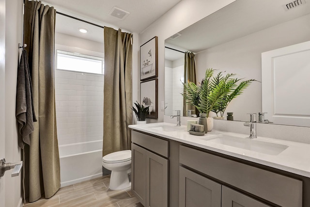 bathroom with toilet, visible vents, and a sink