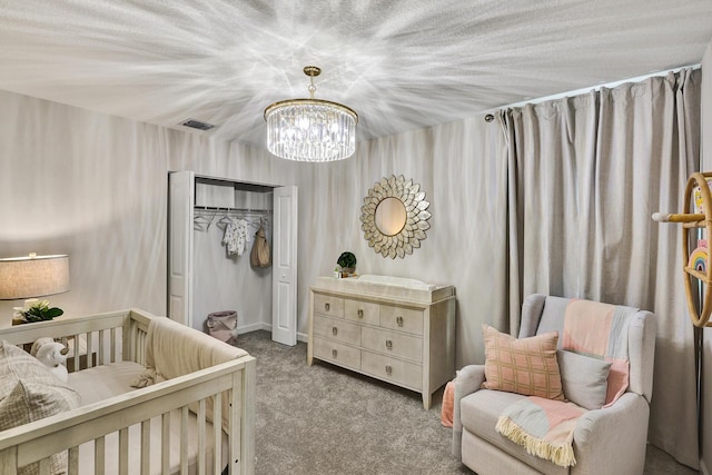 bedroom featuring carpet floors, visible vents, a chandelier, and a closet