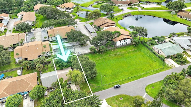 birds eye view of property featuring a water view